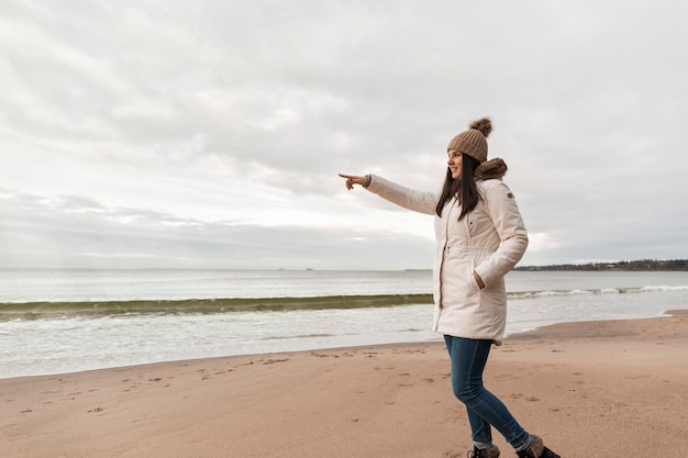 Side view woman pointing at distance