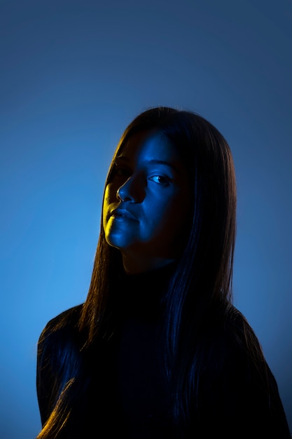 Side view woman posing in blue light