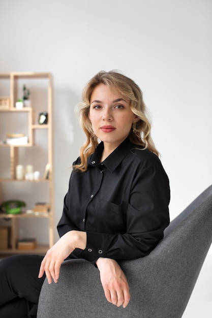 Side view woman posing on chair