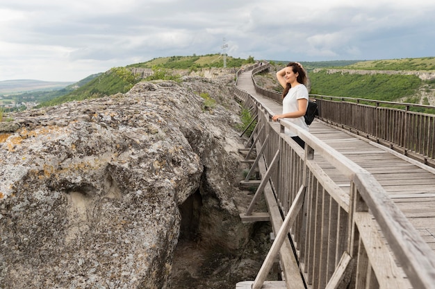 Side view of woman posing in nature on bridge