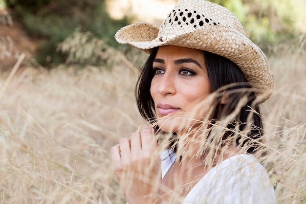 Side view of woman posing in nature outside