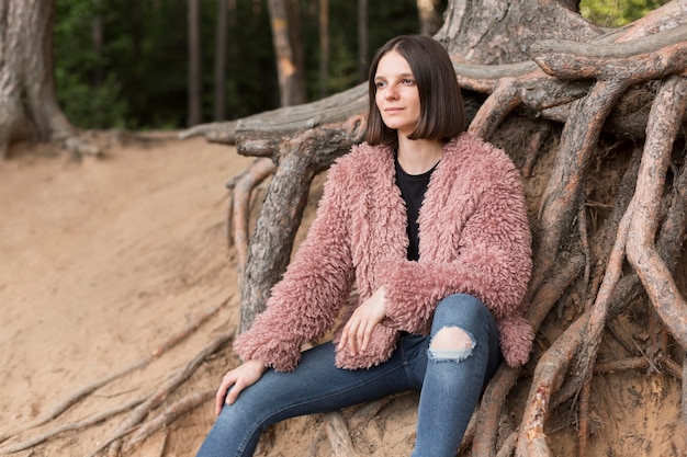 Free photo side view woman posing in nature