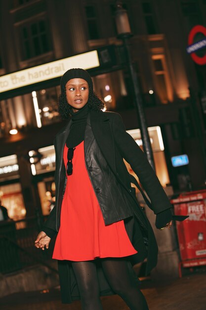 side view woman posing at night with flash