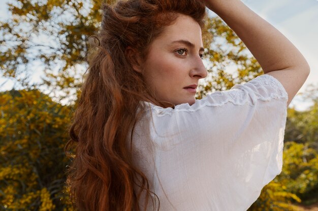 Side view woman posing outdoors