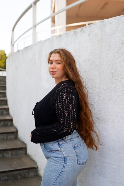 Side view woman posing outdoors