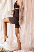 Free photo side view woman posing in shapewear