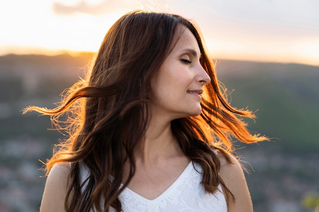 Side view of woman posing at sunset