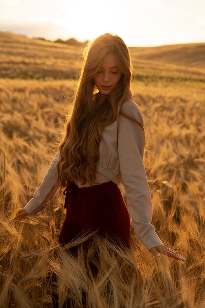 Side view woman posing at sunset