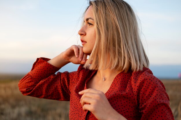 Side view woman posing at sunset