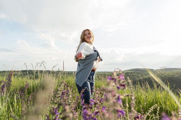 Side view of woman posing through field