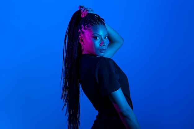 Side view woman posing with blue background