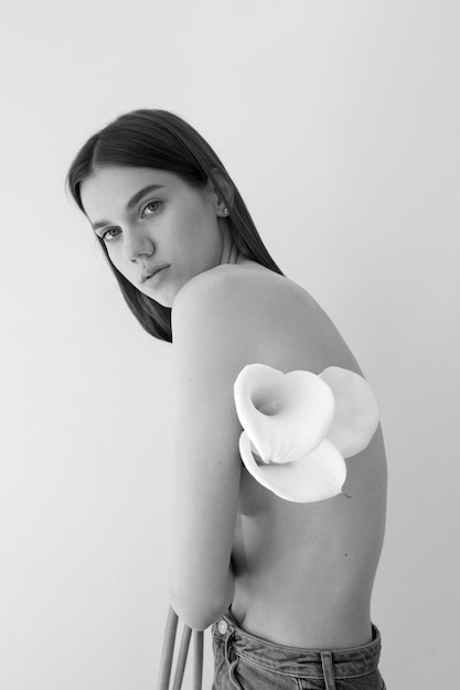 Side view woman posing with flowers