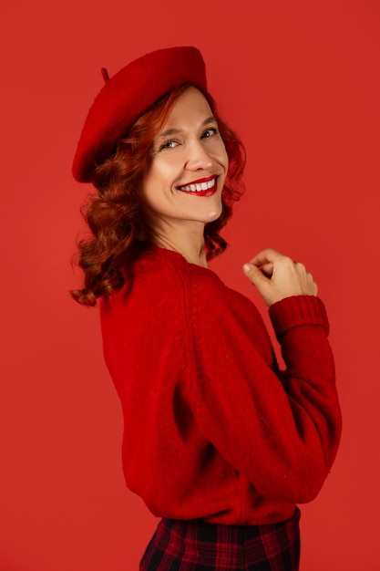 Free photo side view woman posing with red outfit