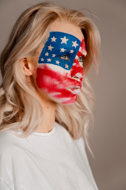 Side view woman posing with usa makeup