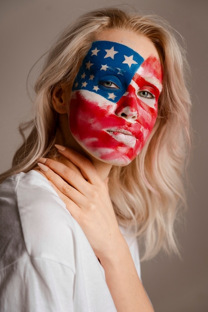 Free photo side view woman posing with usa makeup