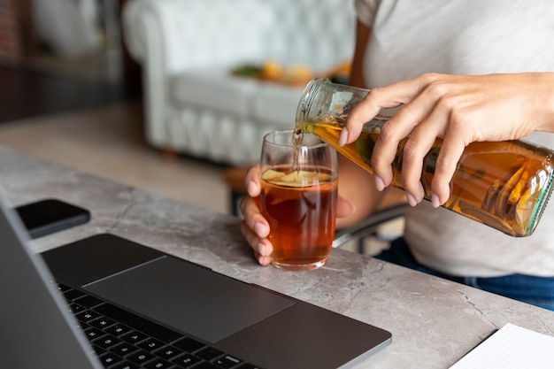 Free photo side view woman pouring kombucha