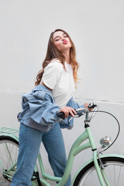 Side view of woman pouting her lips while sitting on her bike