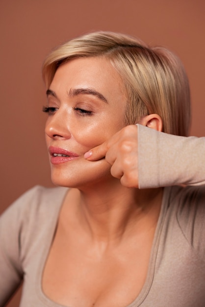 Side view woman practicing facial yoga