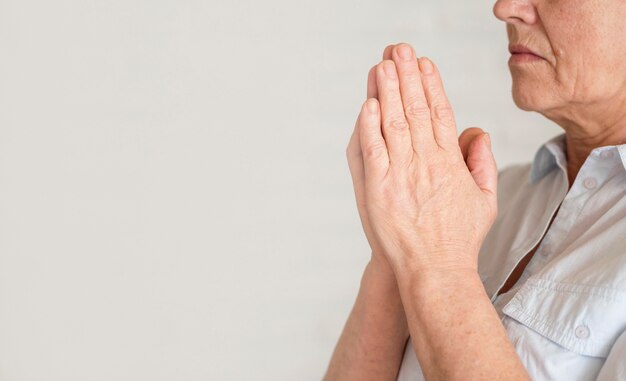 Side view of woman praying with copy space