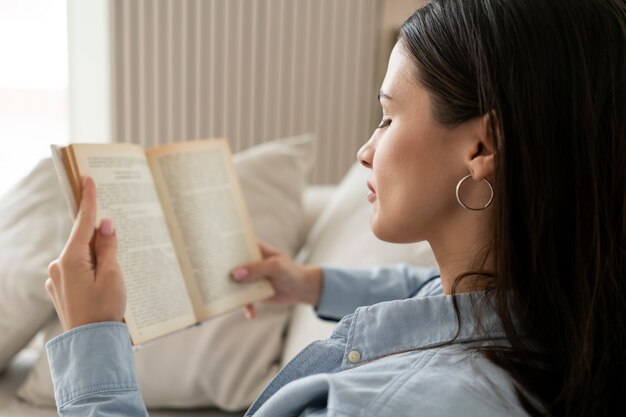 Side view woman reading on couch
