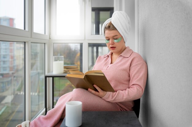 Side view woman reading at home