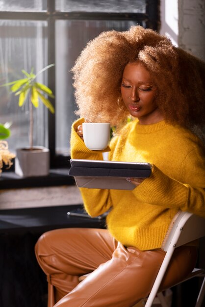 Side view woman reading on tablet