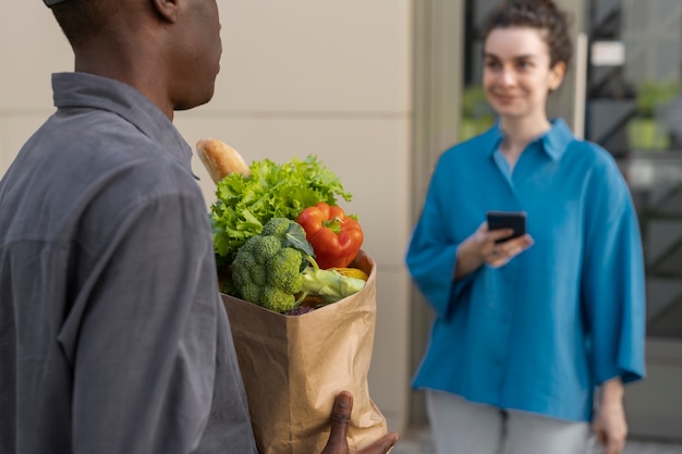 Side view woman receiving groceries