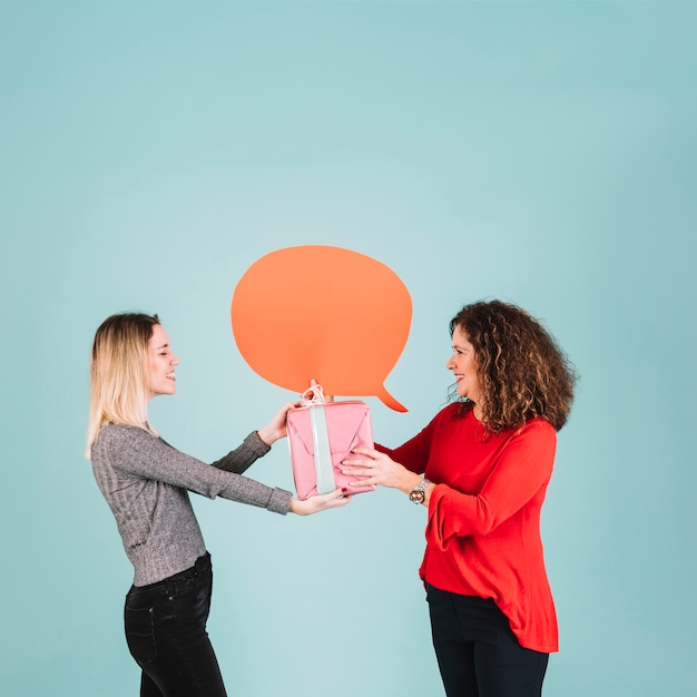 Side view woman receiving present from daughter