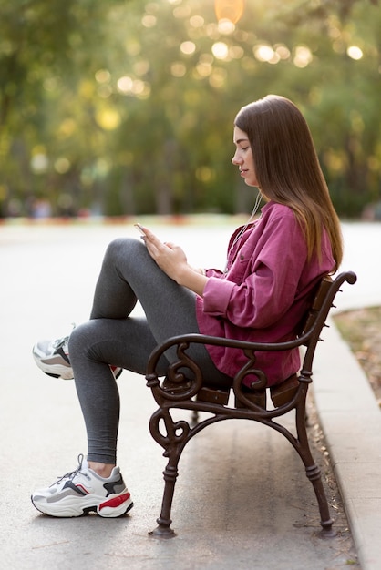 Side view woman relaxing on the bench