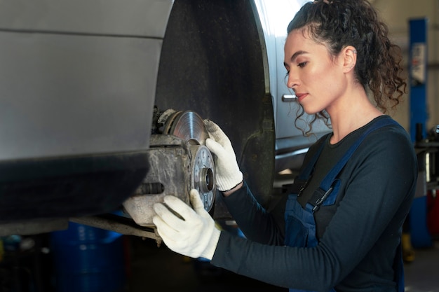 Side view woman repairing car