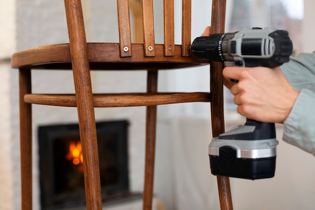 Side view woman restoring wooden furniture