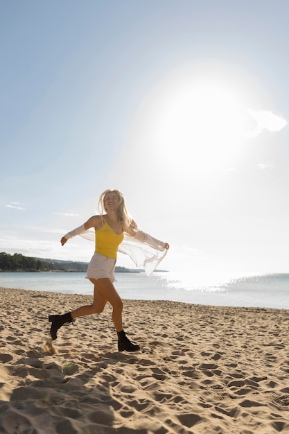 Side view of woman running on beach