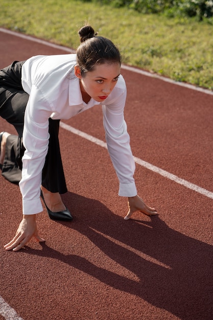 Side view woman running in suit