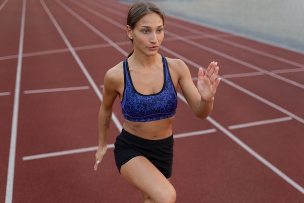 Side view woman running on track