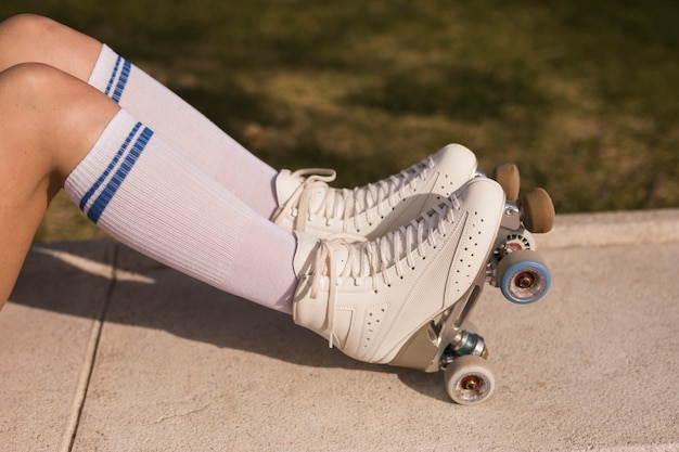 Side view of a woman's leg with white roller skate