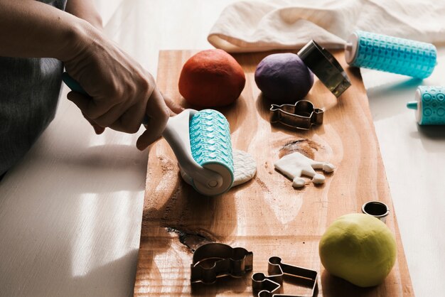 Side view of woman shaping plasticine