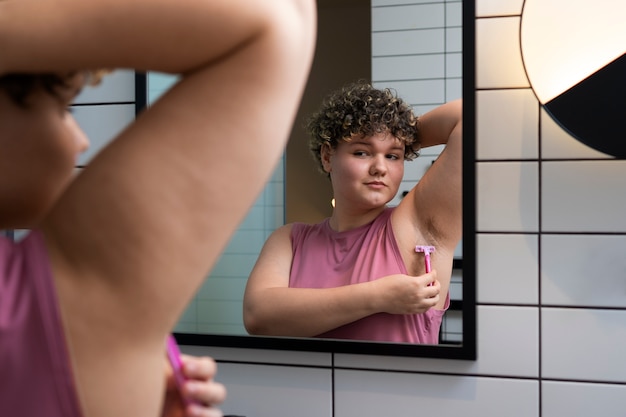 Side view woman shaving at home