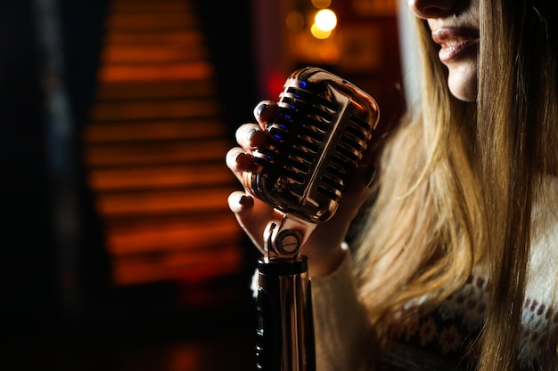 Side view woman singing microphone