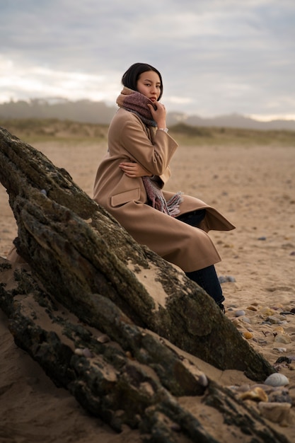 Side view woman sitting on the beach