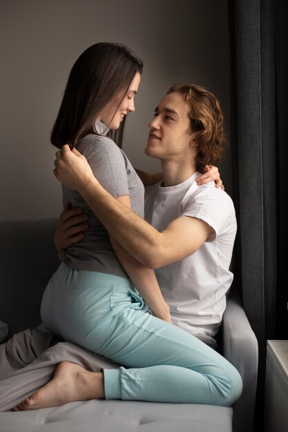 Side view of woman sitting on boyfriend