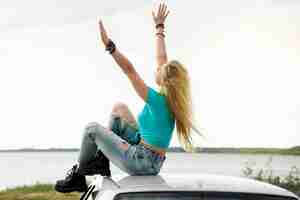 Free photo side view woman sitting on car