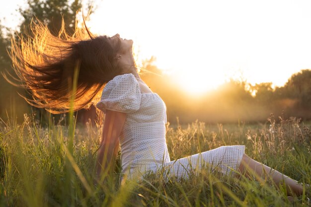 Side view woman sitting on grass