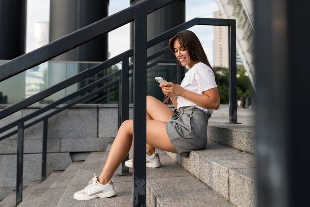 Side view woman sitting on stairs