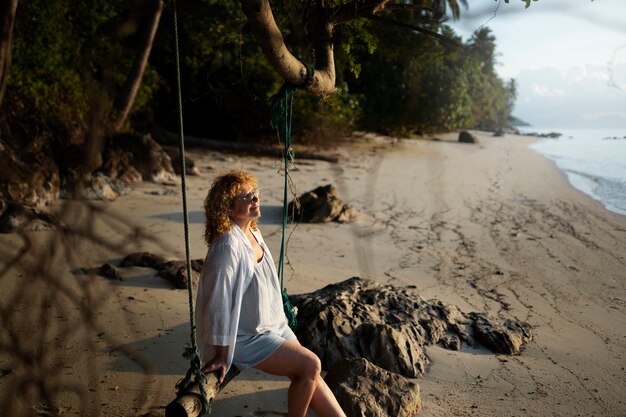 Side view woman sitting on a swing