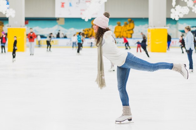 Side view woman skating on one leg