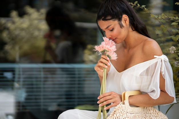 Side View Woman Smelling Flowers