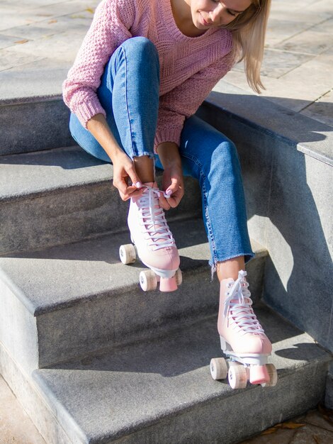 Side view of woman on stairs with roller skates