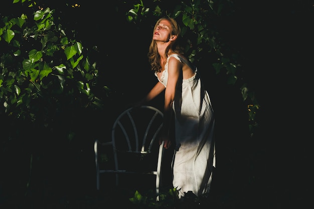 Free photo side view woman stepping on chair