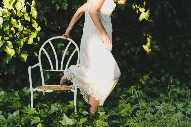 Side view woman stepping from chair