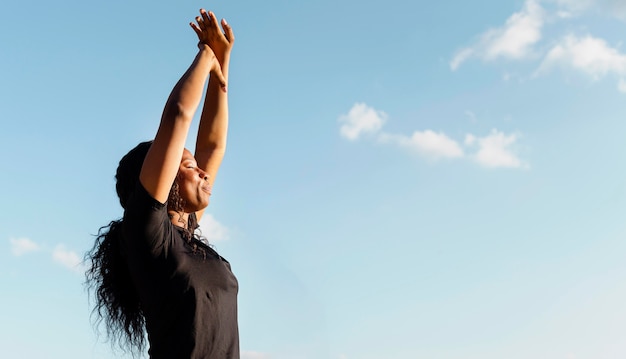 Side view of woman stretching with copy space